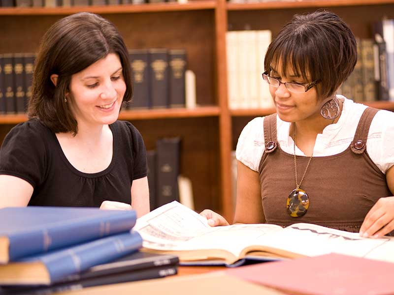 student studying in cabell library with her professor