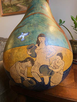 Pamunkey gourd art of three women collecting water as a blue jay flies above them