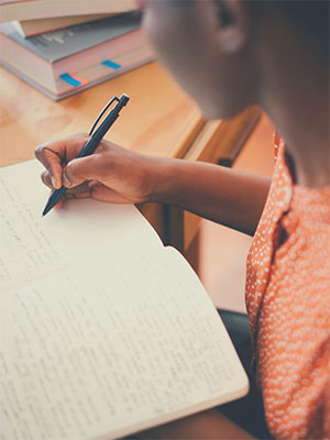 woman writing in a journal